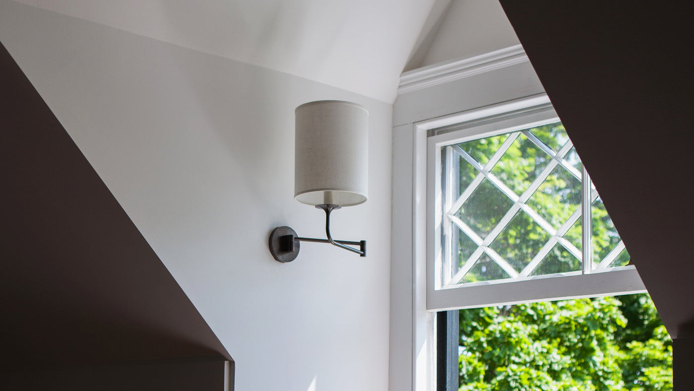 A Veronique Swing-Arm Sconce in Oil Rubbed Bronze, installed under the eave in the attic of a Hudson Valley home.