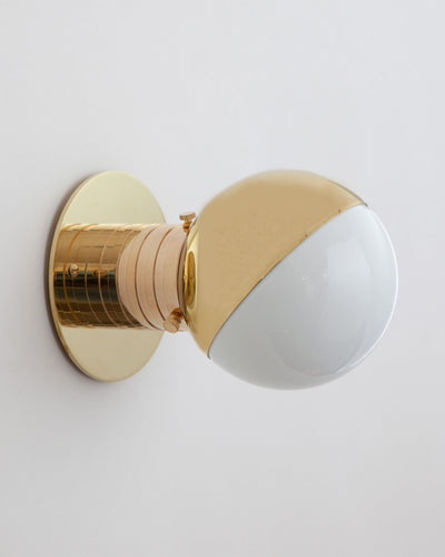 Commune Collection image 1 of a Mini Globe Sconce with Shade made-to-order.  Shown in Polished Brass with 45 Degree Eyelid Shade.