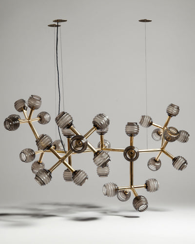 Robert and Trix Haussmann Collection image 1 of a Nebula Chandelier with Beehive Glass made-to-order.  Shown in Polished Brass with Dusk glass.