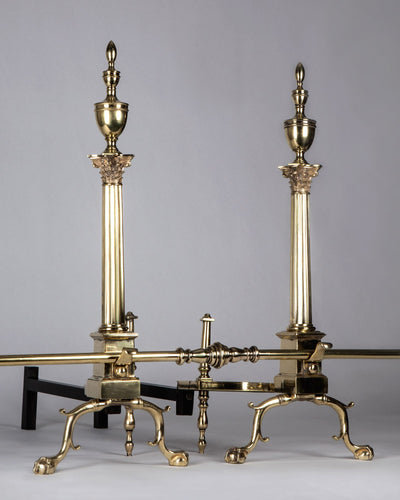 Vintage Collection image 1 of a pair of Corinthian Column Andirons with Urn Form Finials antique in a Polished Brass finish.
