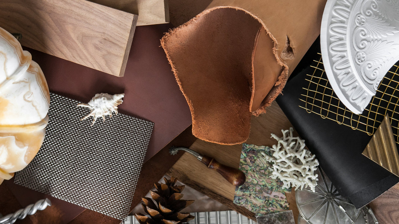 a table spread with natural materials used in Remains light fixtures such as stone, alabaster, leather, wood, brass mesh, aluminum, and more