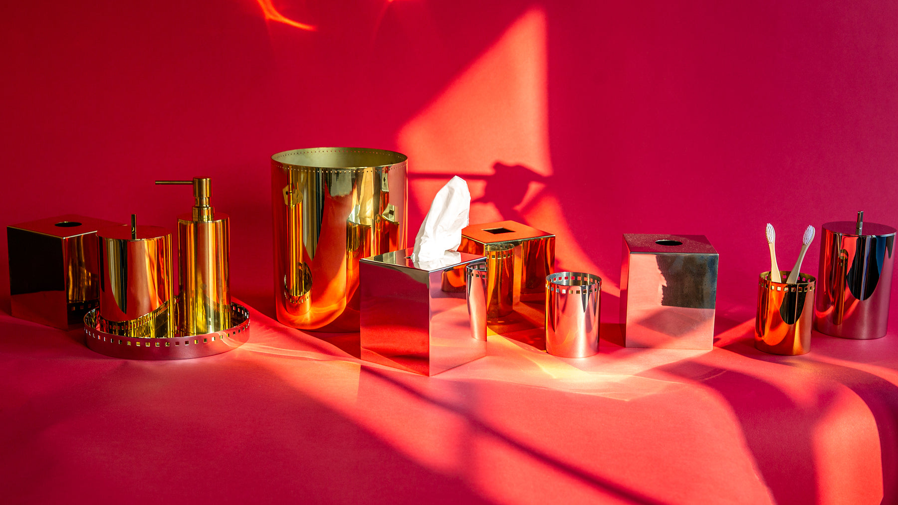a selection of Remains Commune accessory collection products arranged along a red background