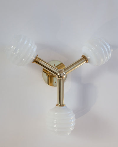 Robert and Trix Haussmann Collection image 1 of a Molecule Wall Sconce with Beehive Glass made-to-order.  Shown in Polished Brass with Sfumato glass.